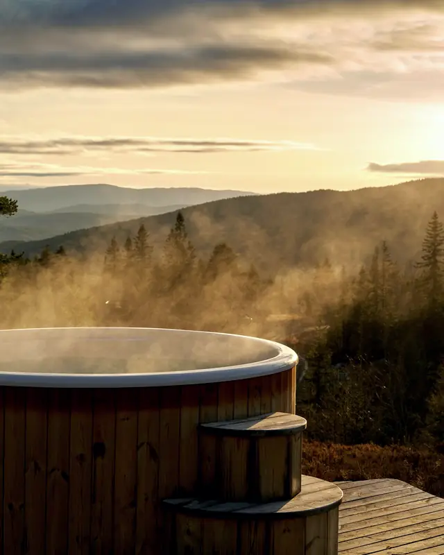 Cedar hot tub on a deck overlooking the water on the North Shore