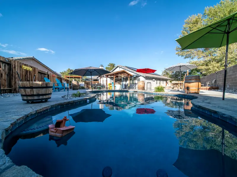 Clean backyard swimming pool with loungers ready for the swim season