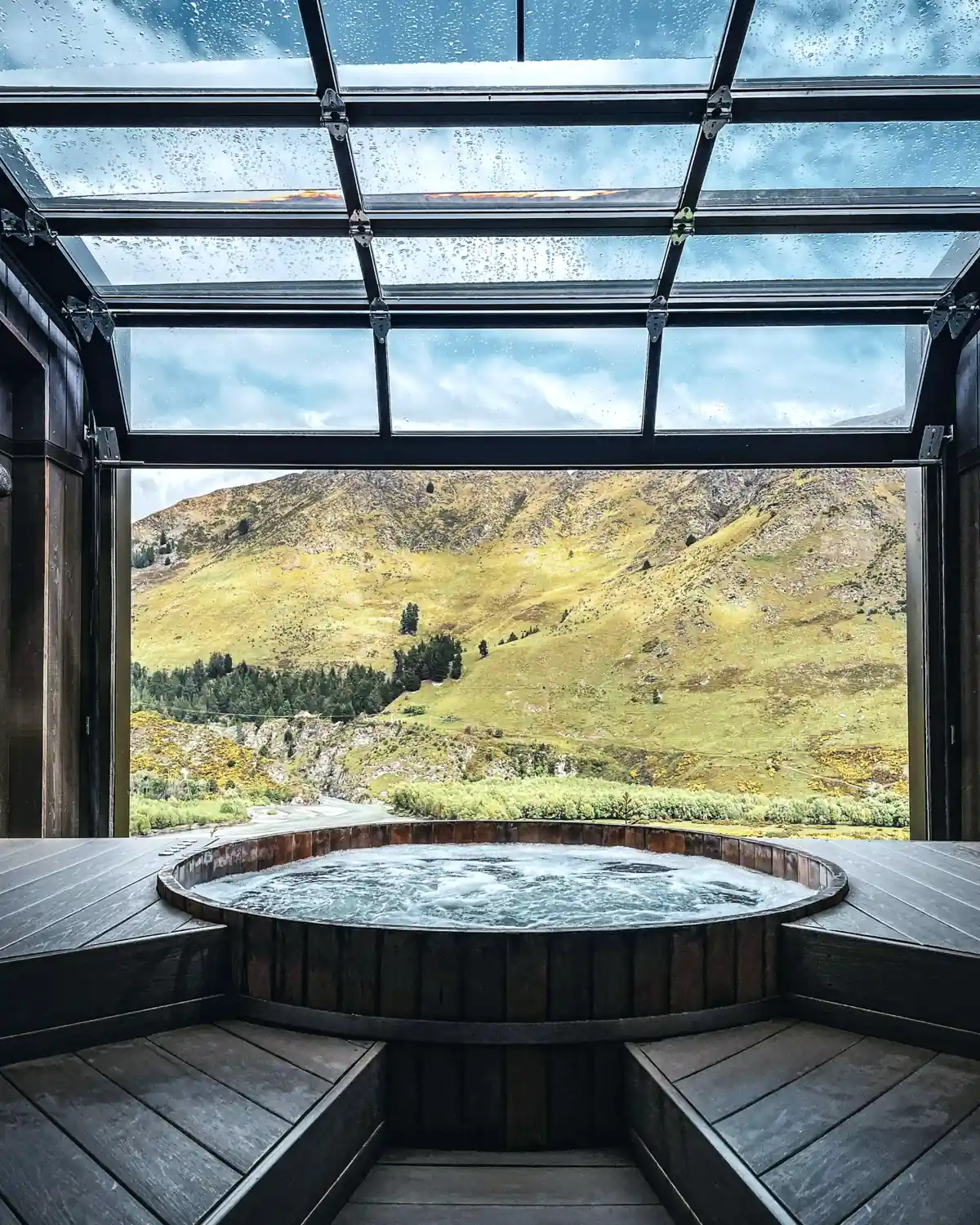 Steaming hot tub on a cedar deck backing onto West Coast forest
